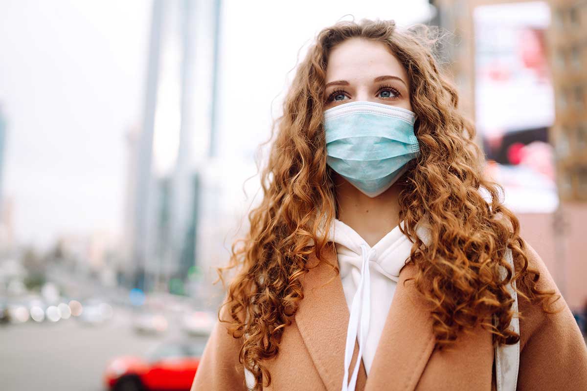 Girl in protective sterile medical mask on her