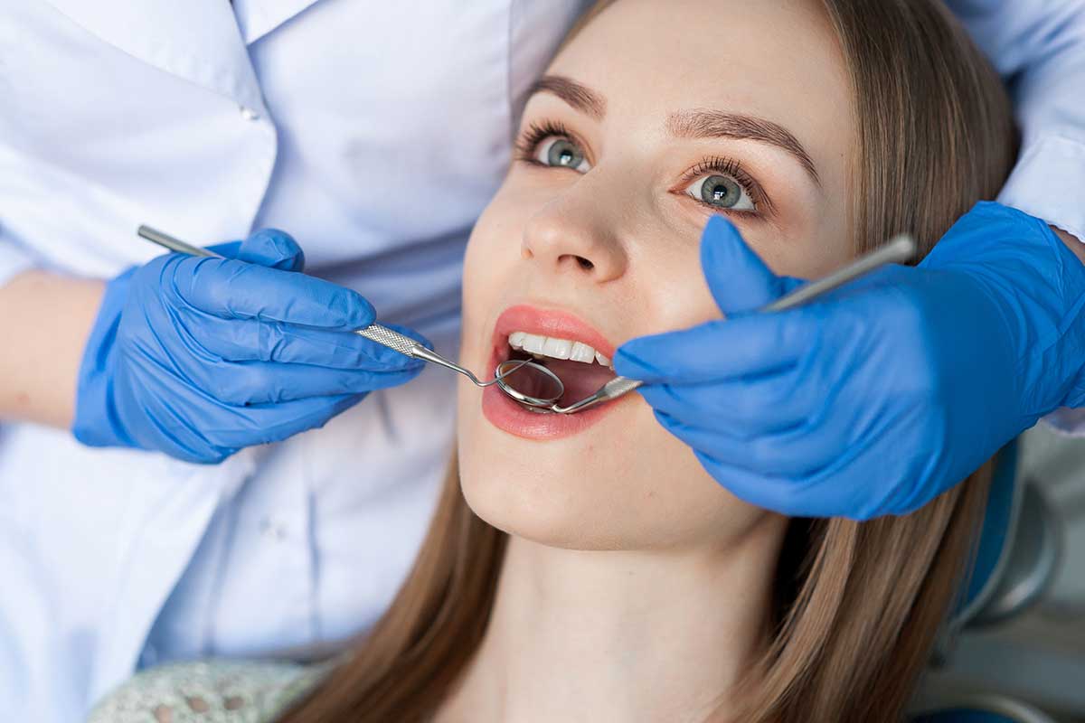 Dental clinic. Dentist examining a patients teeth.